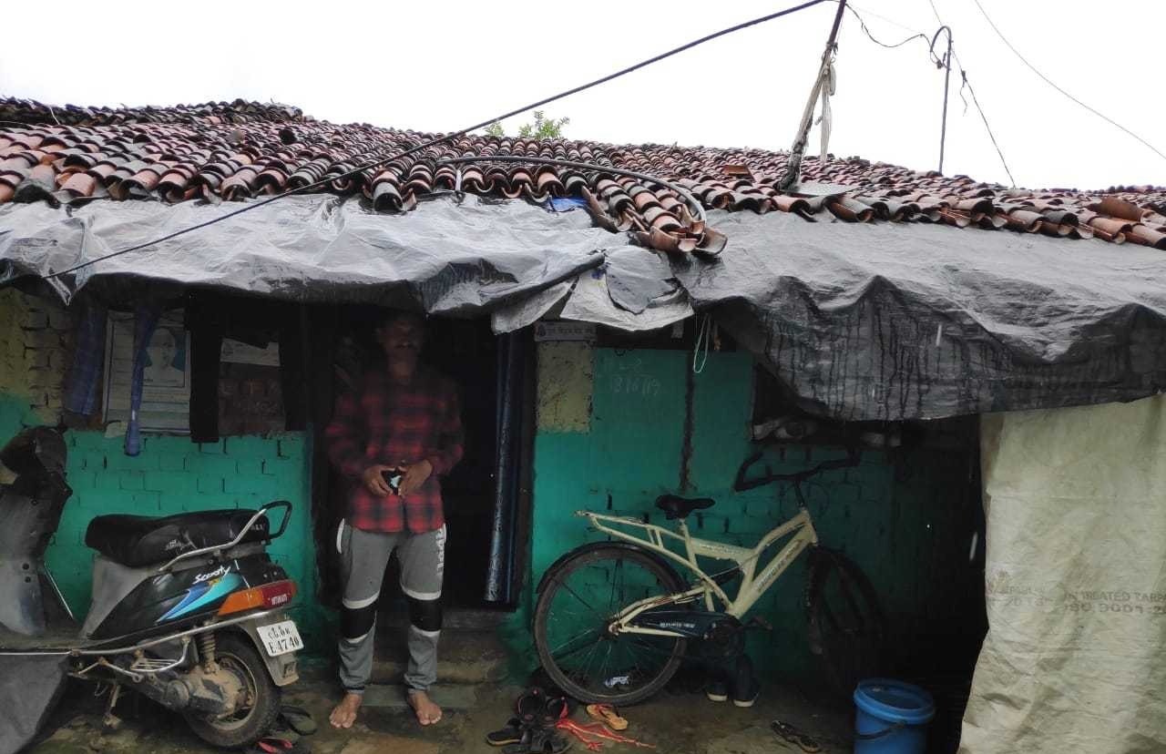 Customer in front of old home